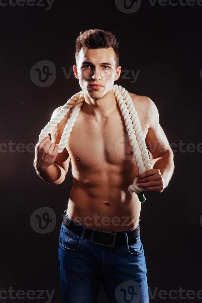 young guy with a naked torso and rope photo