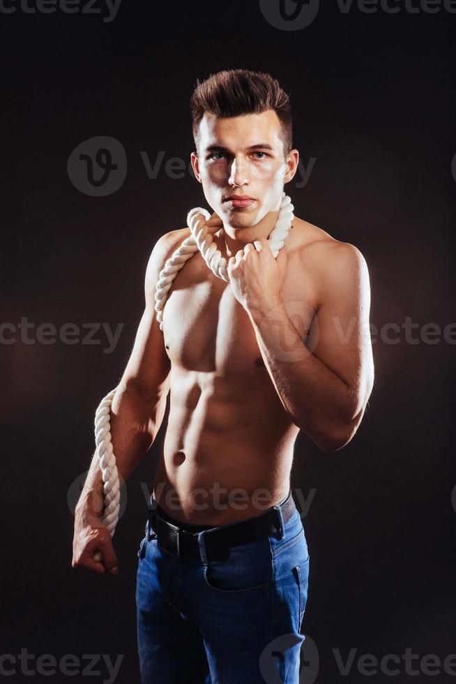 young guy with a naked torso and rope photo