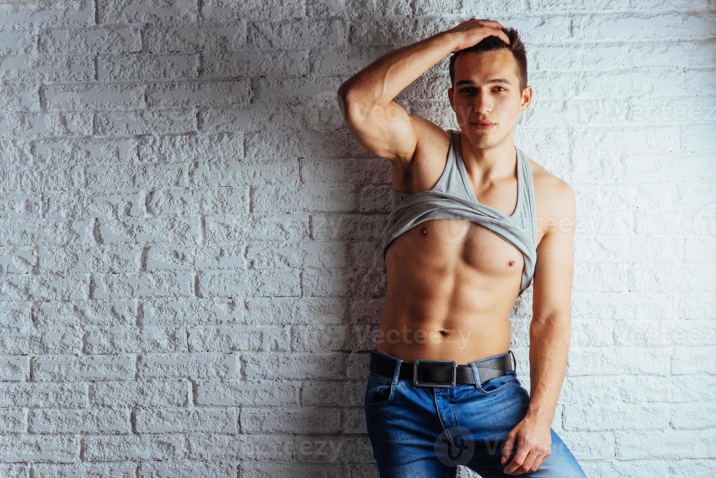 Portrait of a man with nude torso fitness standing photo