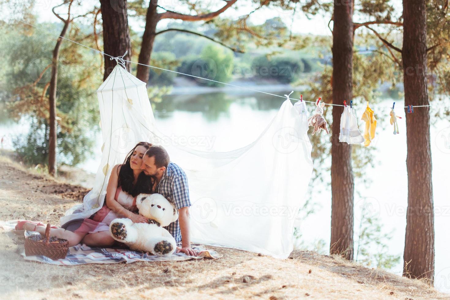 pregnant woman with her husband at  picnic photo