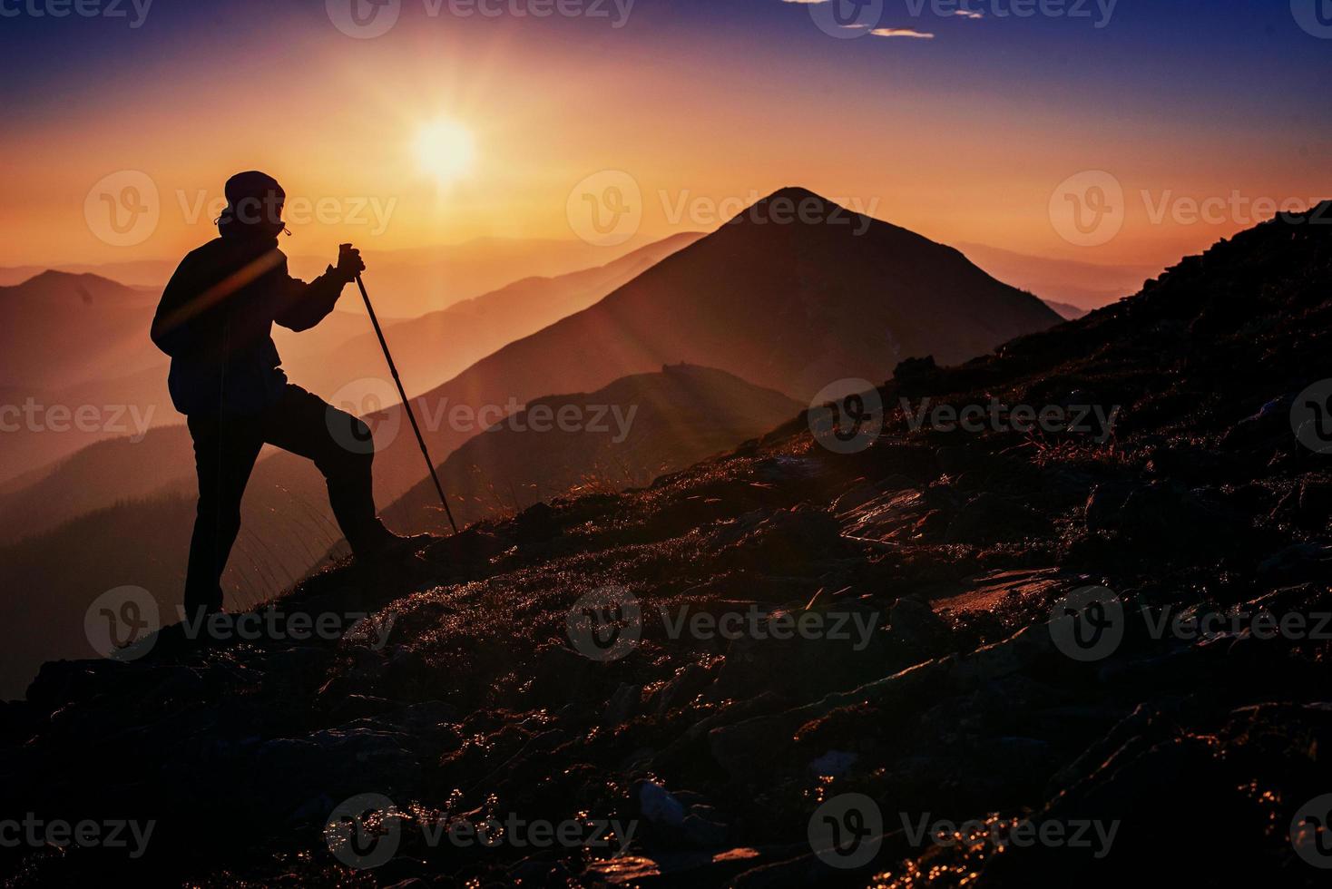 tourist in the mountains at sunset photo