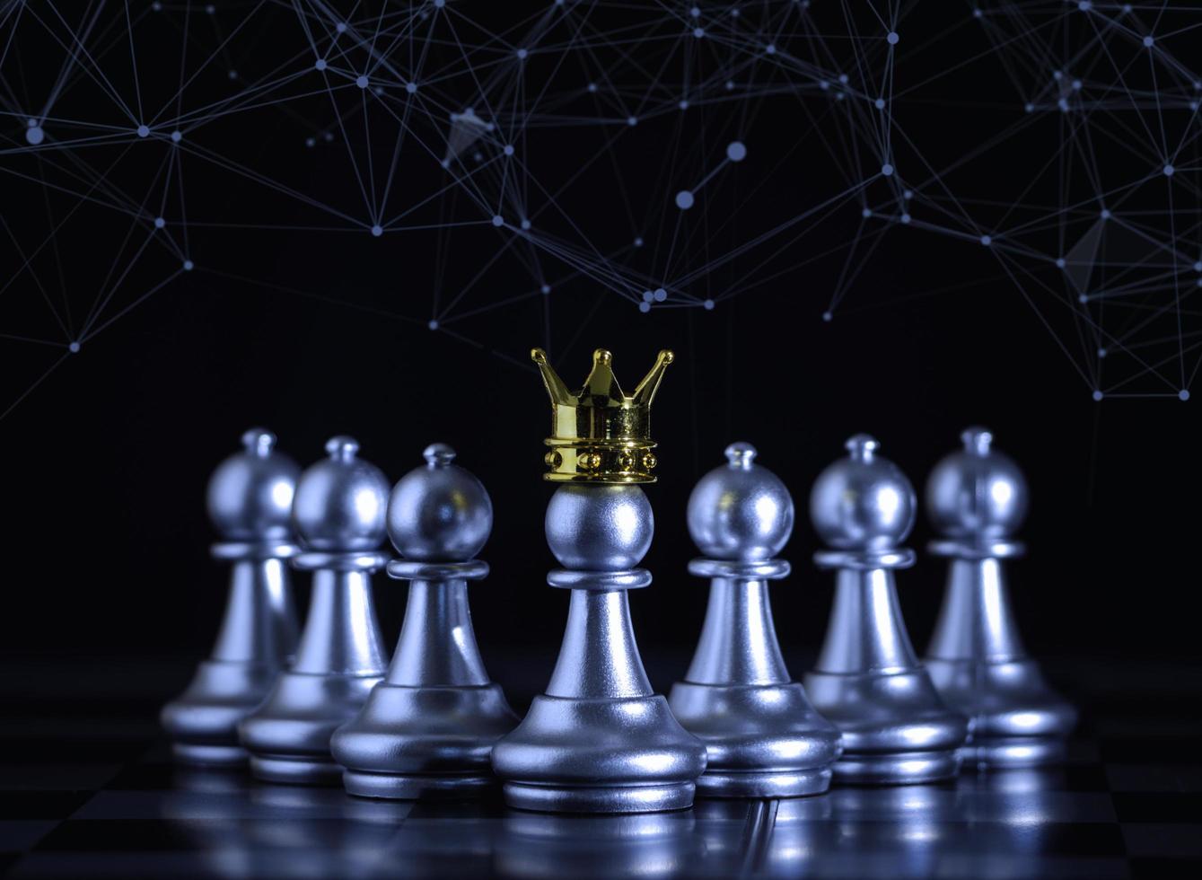 A silver pawn standing crowned in battle chess game on board with gold chess  background. successfully in the competition with technology network  background. Management or leadership strategy concept. 6844707 Stock Photo  at