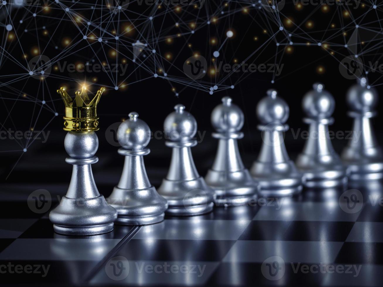 Silver chess pawn wear gold crown to leadership on chess board with network and communication to fighting with teamwork to victory, business strategy concept for success. photo