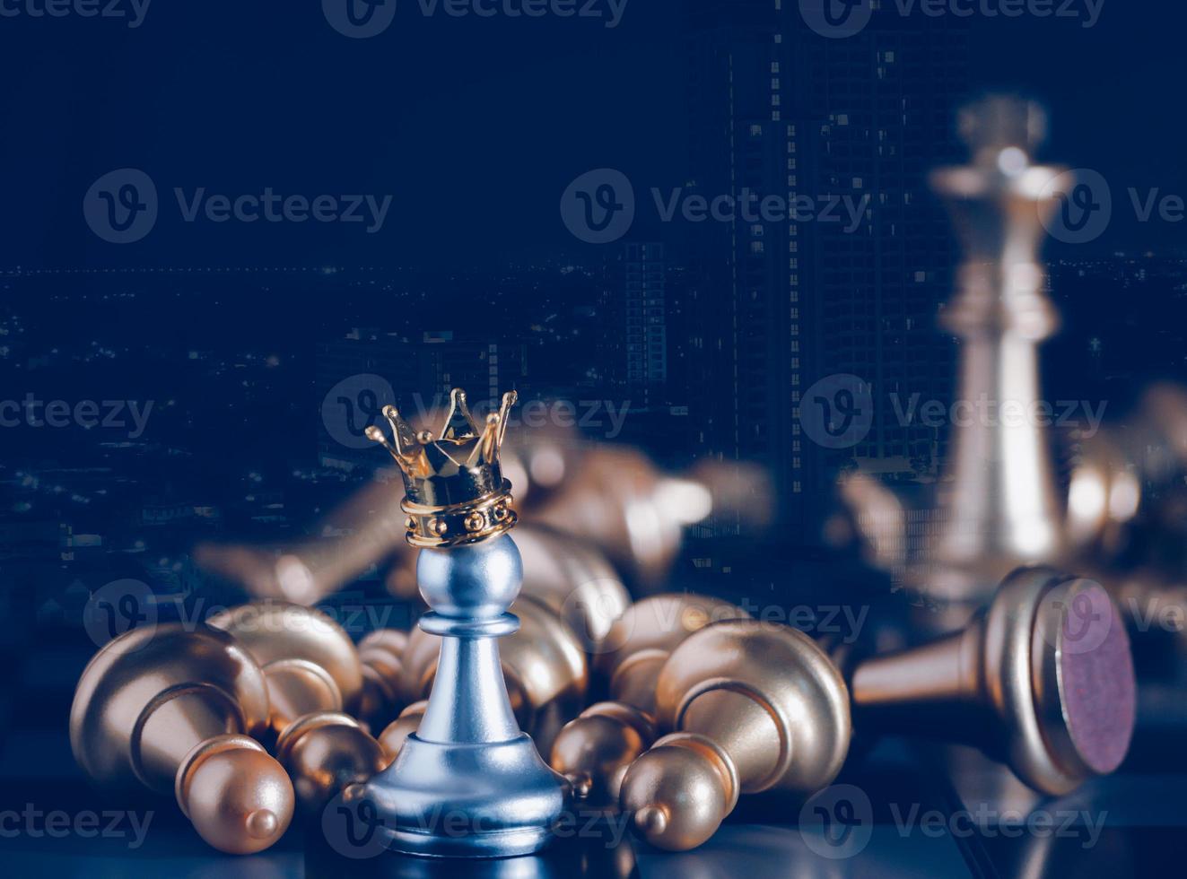 A silver pawn standing crowned in battle chess game on board with gold chess background. To fighting with teamwork to victory, business strategy concept and leader and teamwork concept for success. photo
