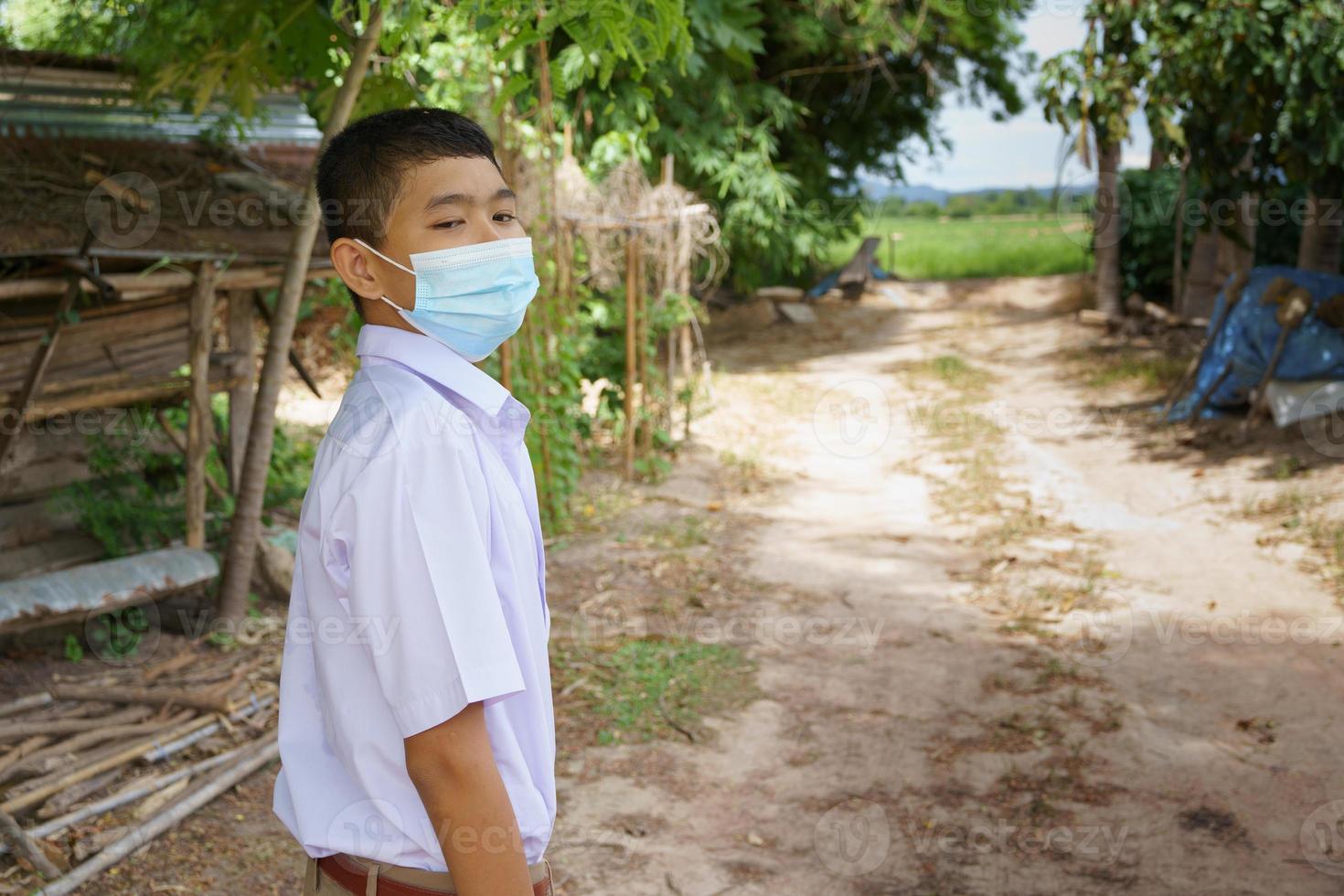 male student wearing anti virus mask going to school,prevent corona virus photo