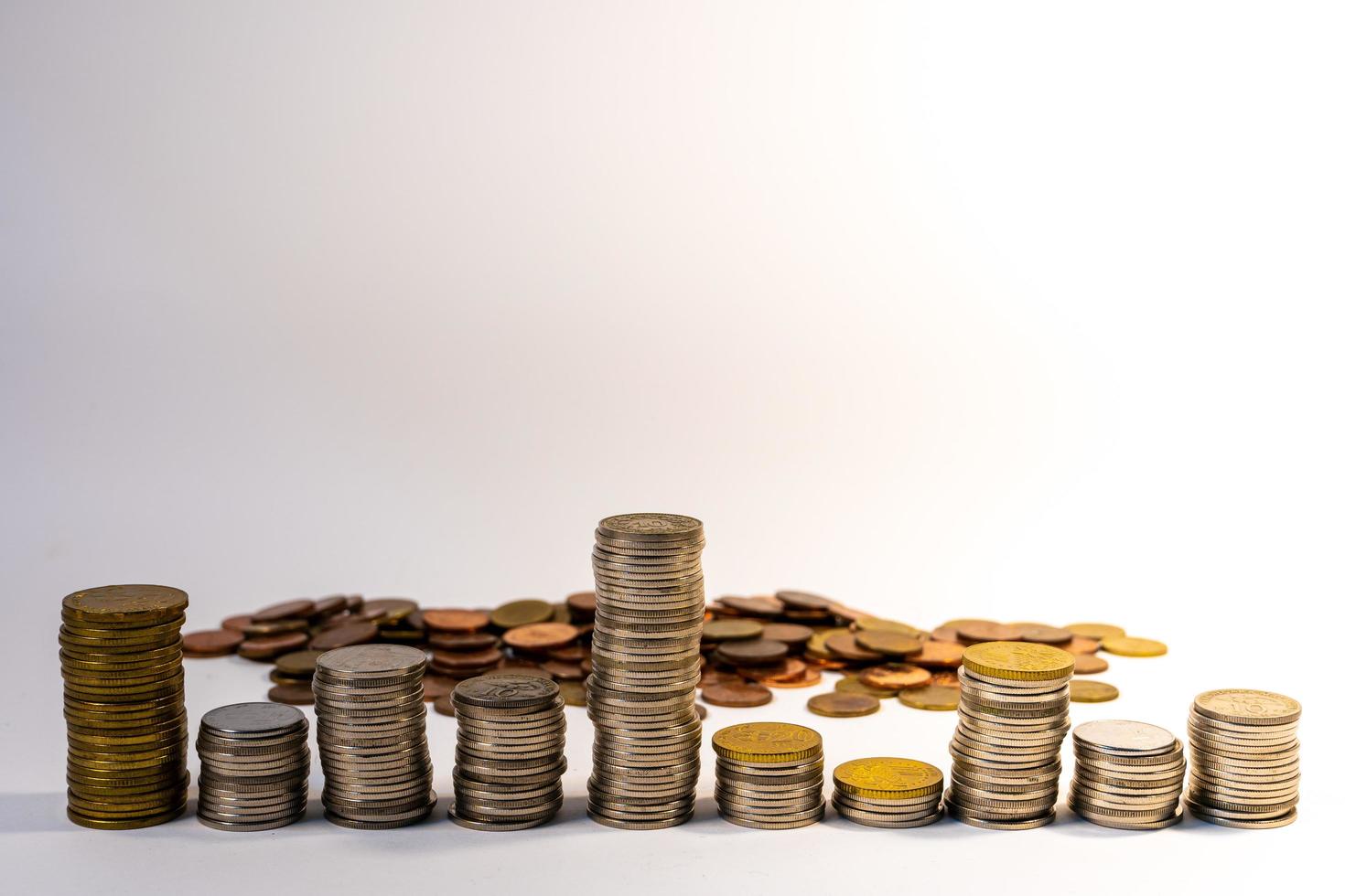 Different coin heights mean uncertainty in investments,investing is risky, Business and finance concept. photo