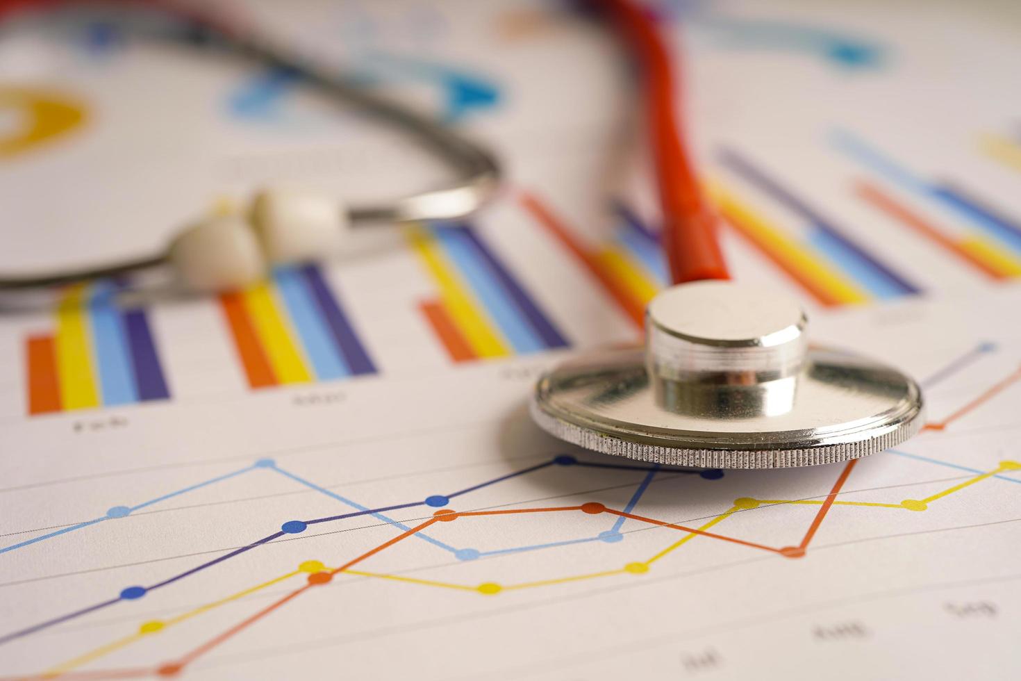 Stethoscope on charts and graphs spreadsheet paper, Finance, Account, Statistics, Investment, Analytic research data economy and Business company concept. photo