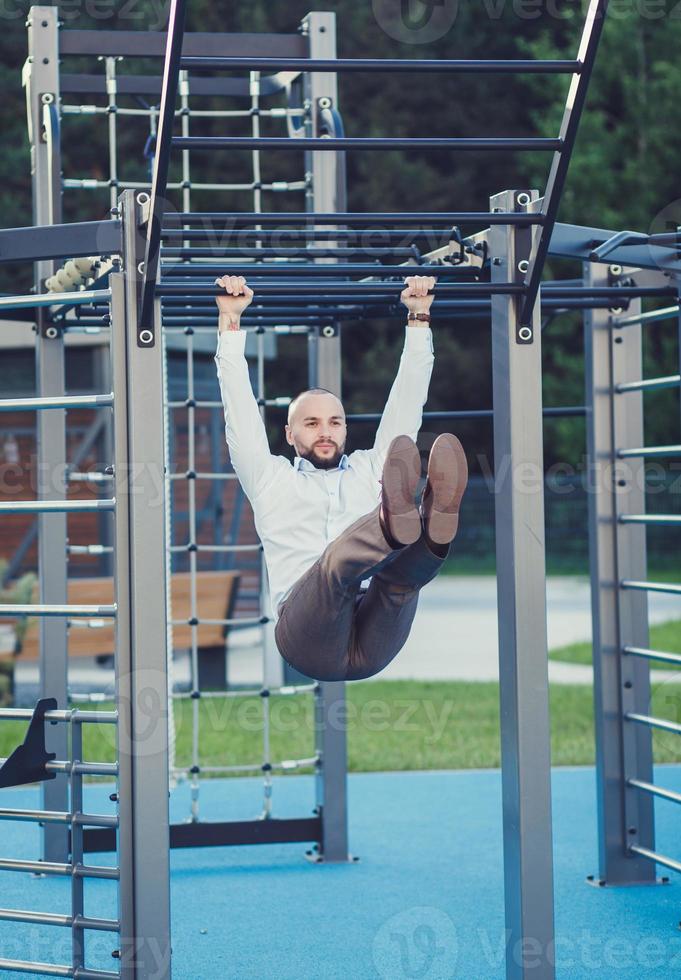 businessman in a shirt and trousers is doing exercises photo
