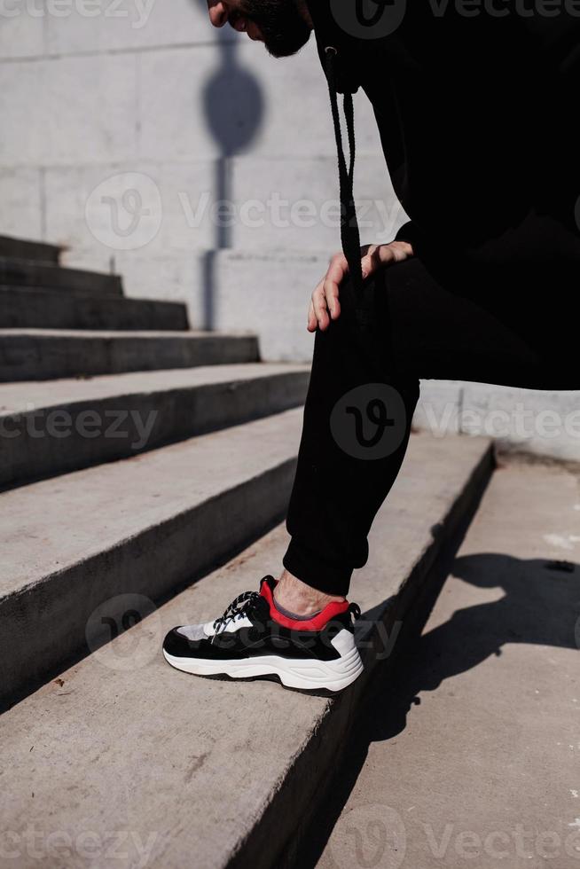 male runner stretches his knee photo