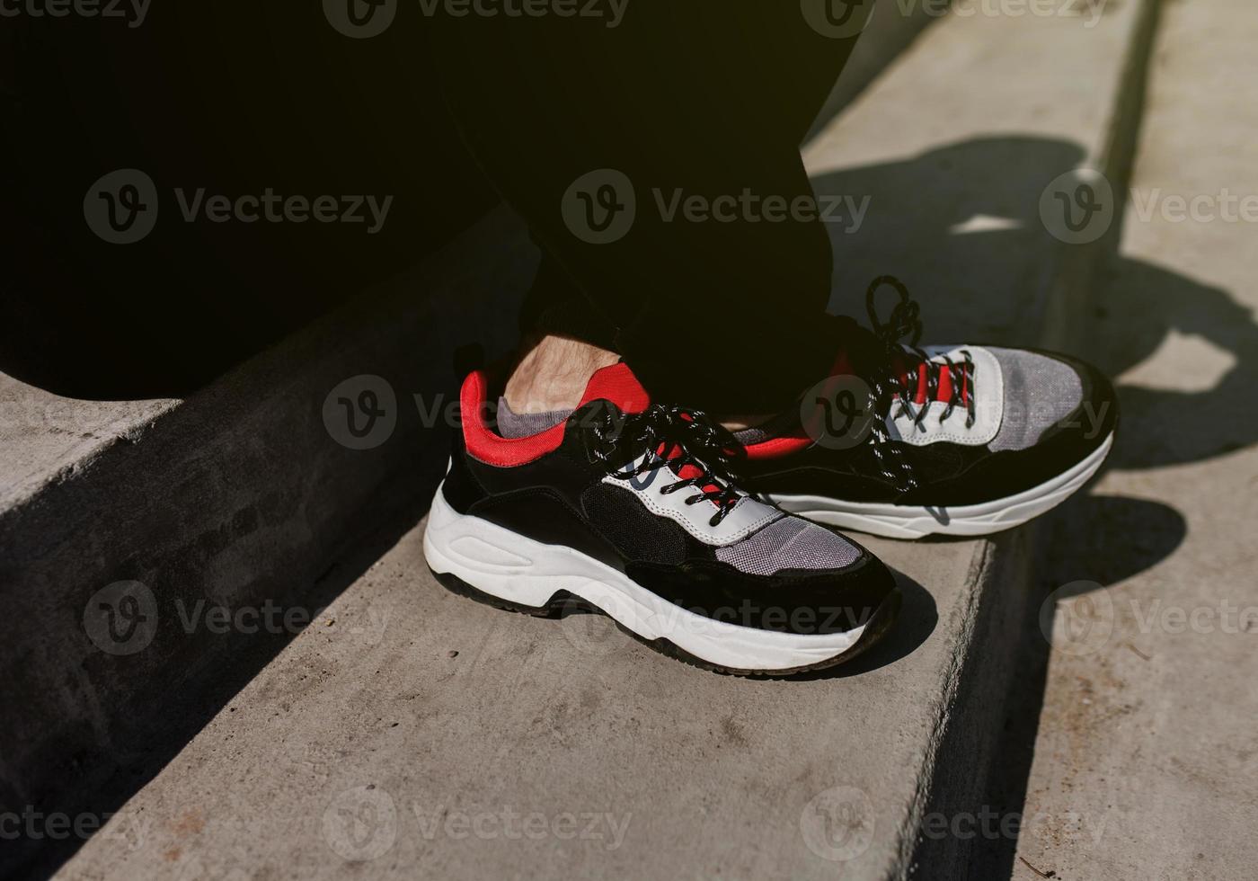 Close-up of man on sneakers photo