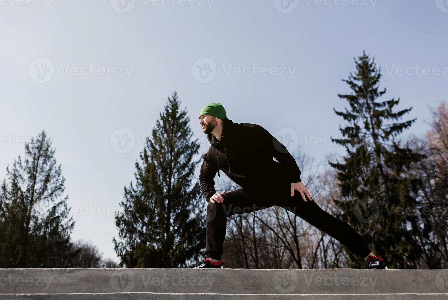 Man runner in a tracksuit and sneakers photo