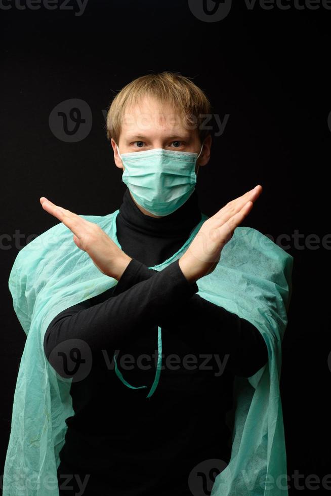 Middle-aged man in a protective medical coat and mask. Coronavirus protection concept photo