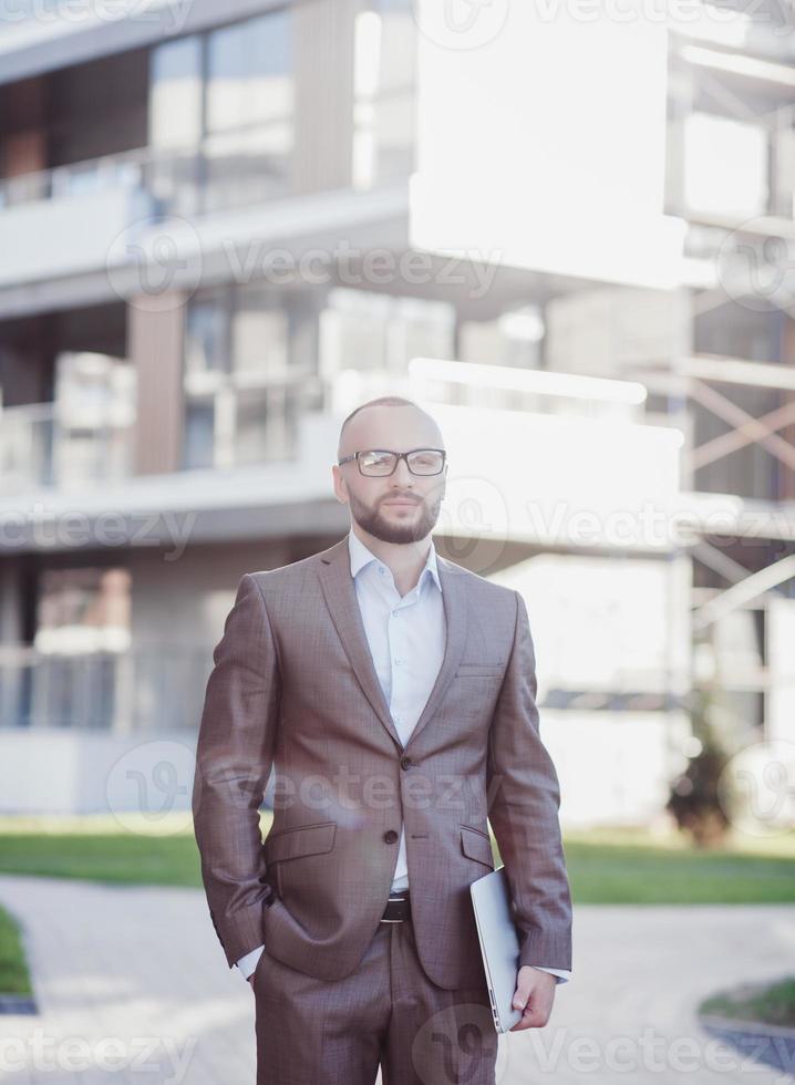 Confident young man in full suit photo