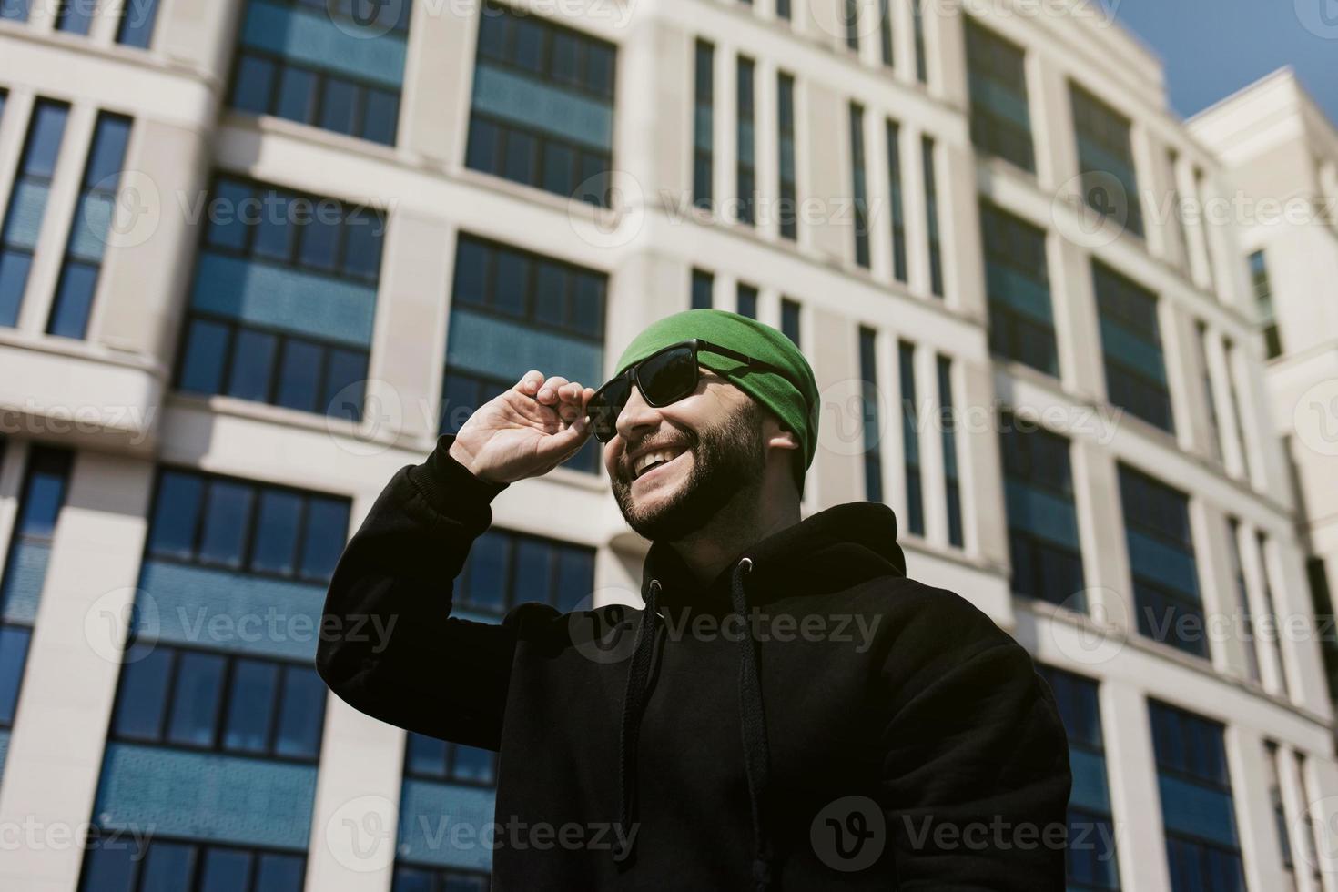 man wearing sunglasses in city photo