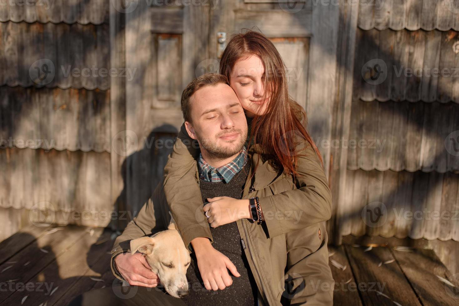 Lovely couple spending autumn day outdoors with their dog photo