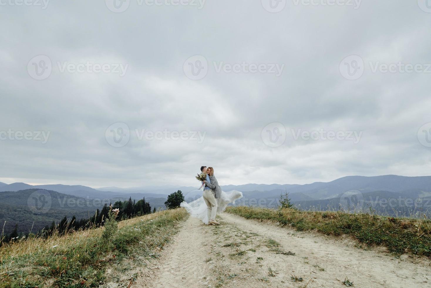 Photoshoot of the bride and groom in the mountains. Boho style wedding photo. photo