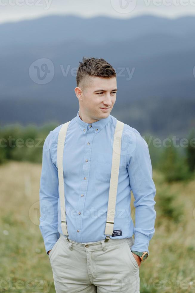 Photoshoot of the groom in the mountains. Boho style wedding photo. photo