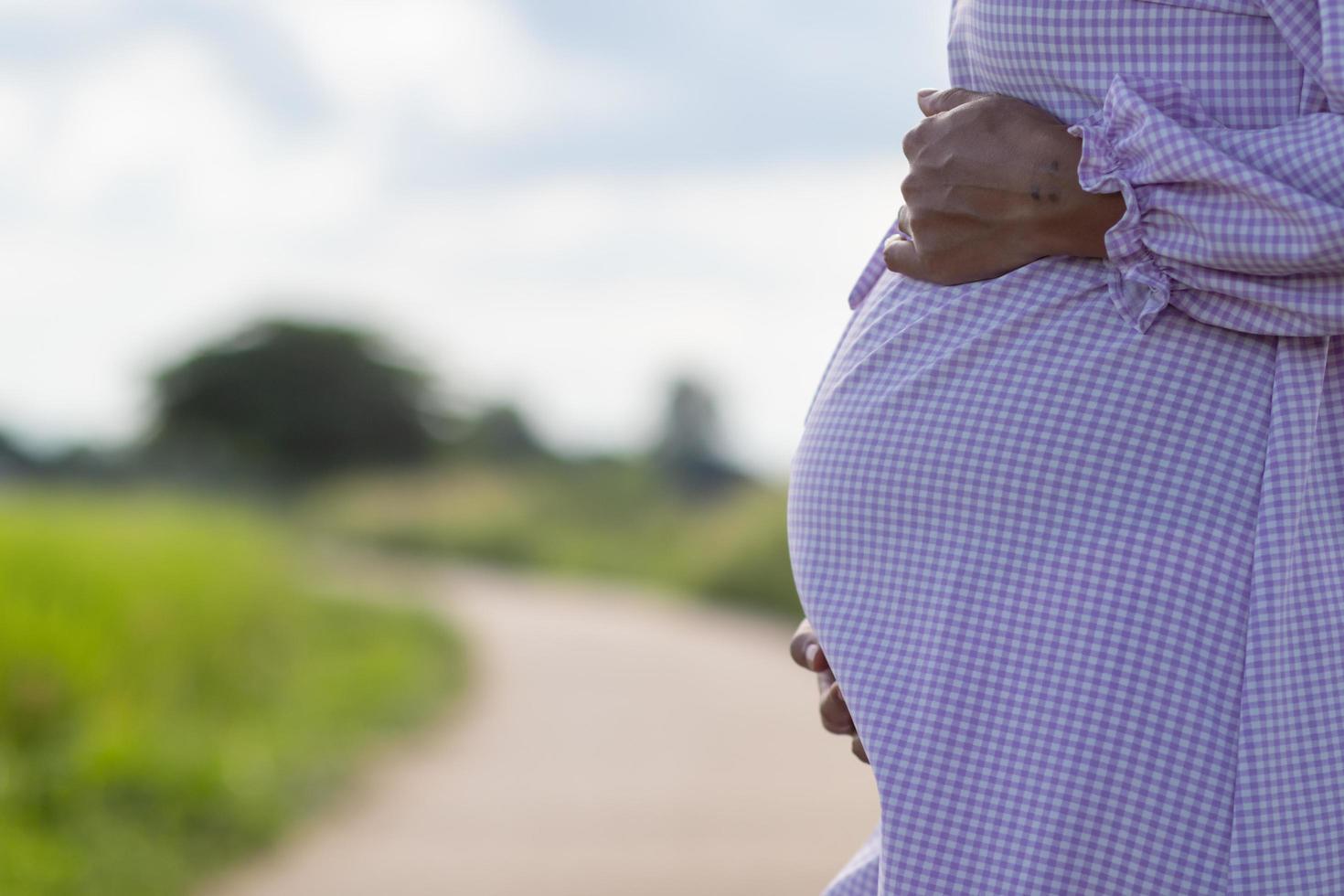 A pregnant woman is waiting for an ambulance to be taken to the hospital. A mother with abdominal pain from an imminent pregnancy is waiting for emergency medical services. photo