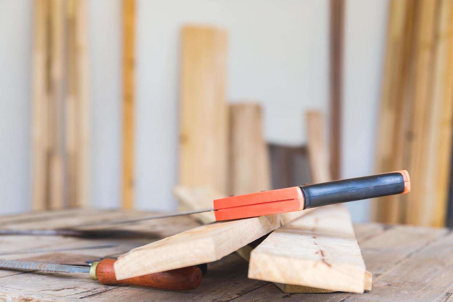 sierra en madera para aserrar tablas, madera contrachapada y otros materiales. madera en la mesa preparada para que el carpintero trabaje para muebles foto