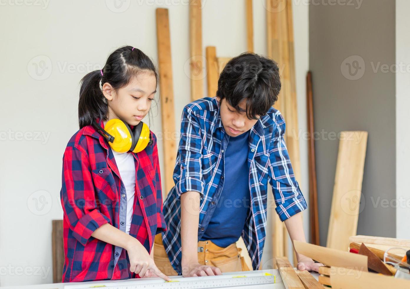 Children team learning woodworking in the craftsman workshop, Kids building a workshop in a carpentry workshop. photo