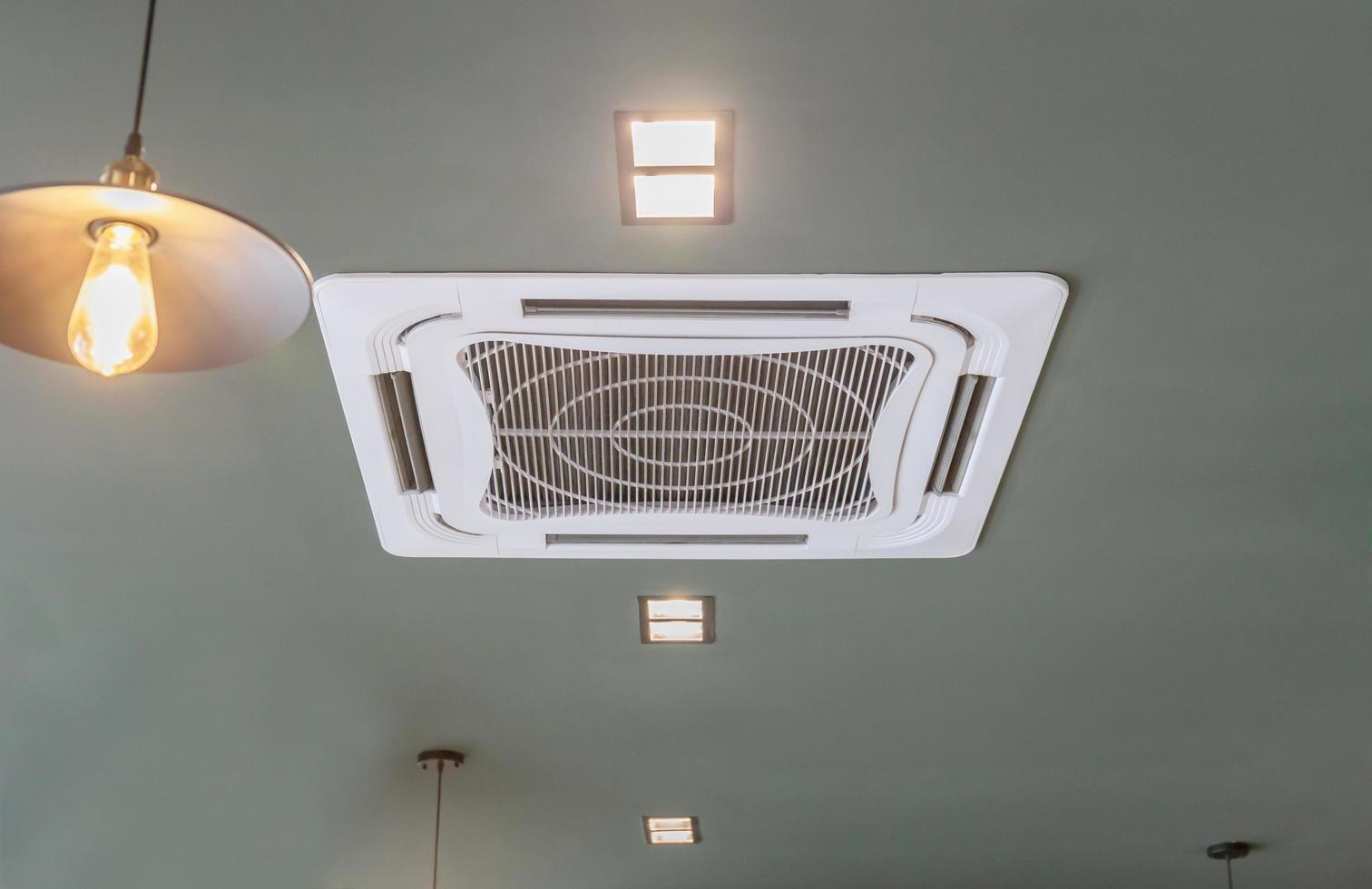 Modern ceiling mounted cassette type air conditioning system in coffee shop photo