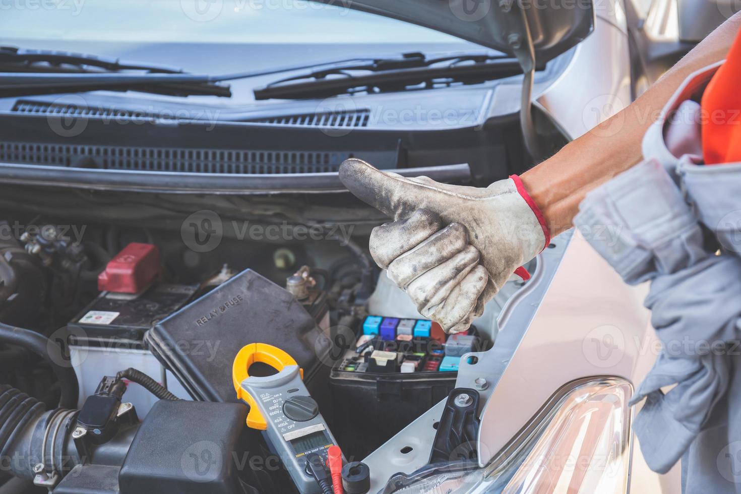 Technician man giving thumb up after checking engine, Car repair and maintenance concepts photo