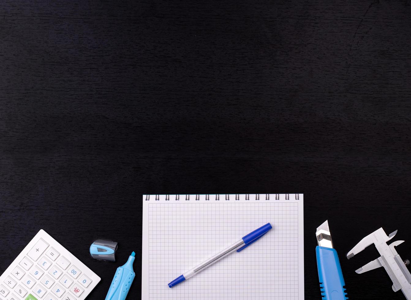 School supplies on black board background. Back to school concept. photo