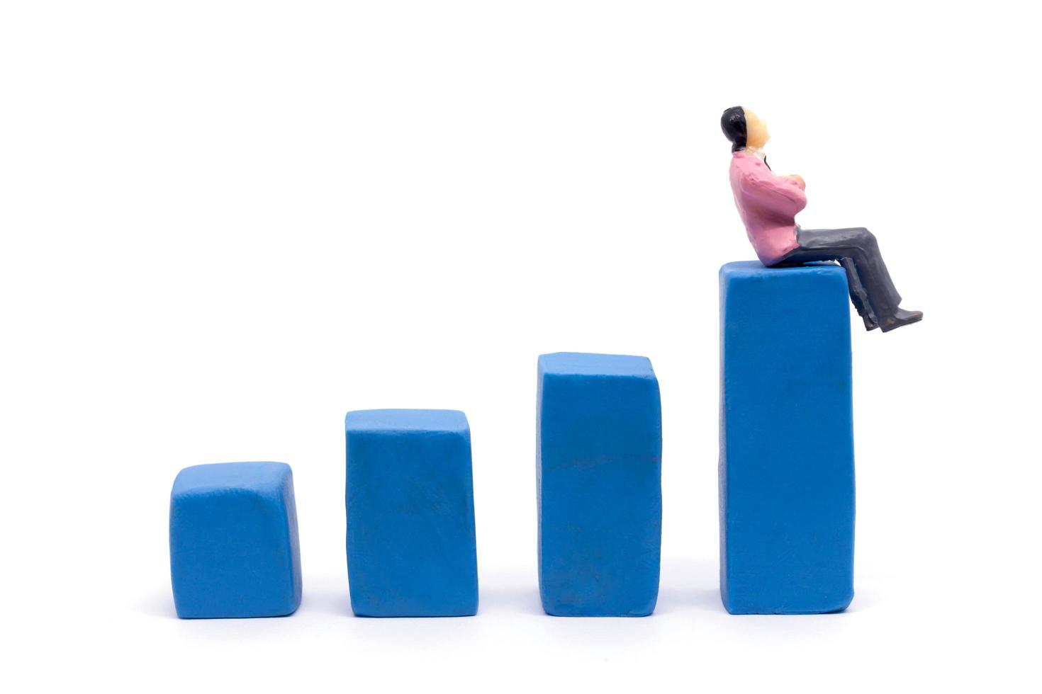Miniature businessman and graph on white background, Business Growth concept photo