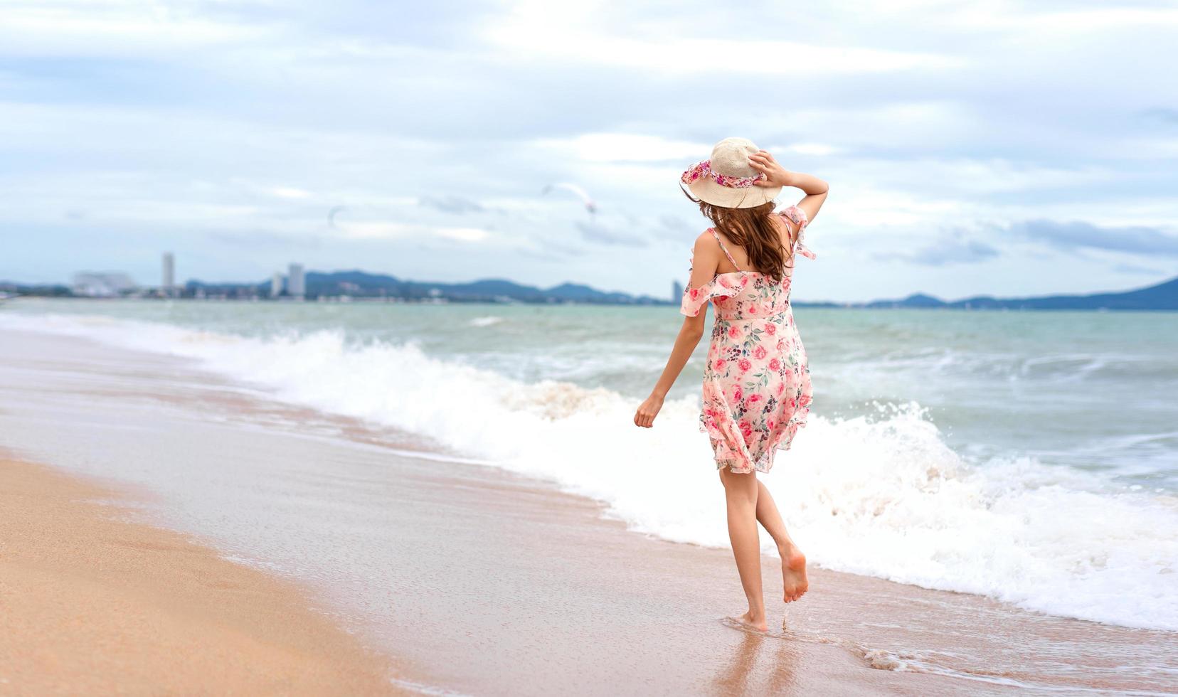 Asian young woman walk and relax on the beach photo