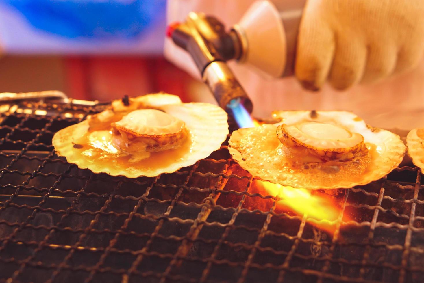 Grilled of scallop at night market street food. photo