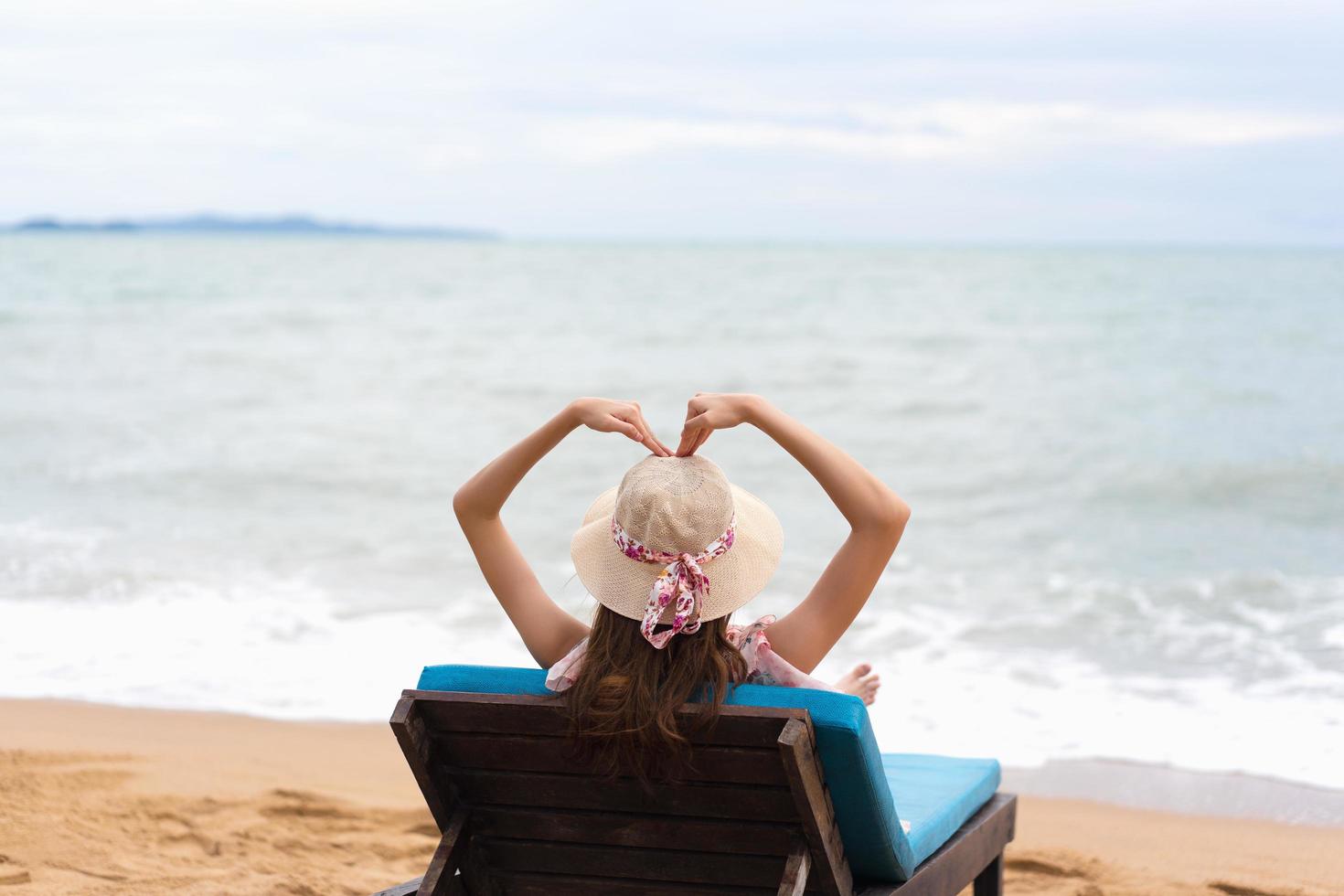 Woman arm up with heart sign. photo