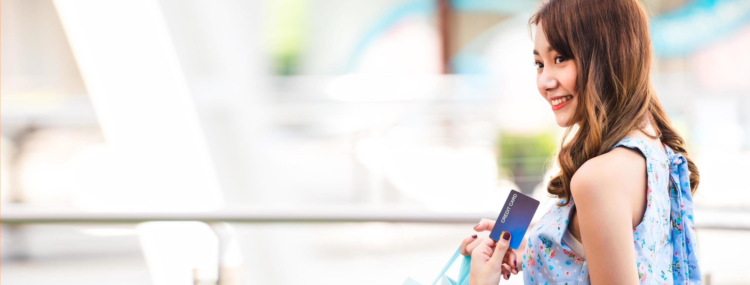 Shopping woman with credit card banner size photo