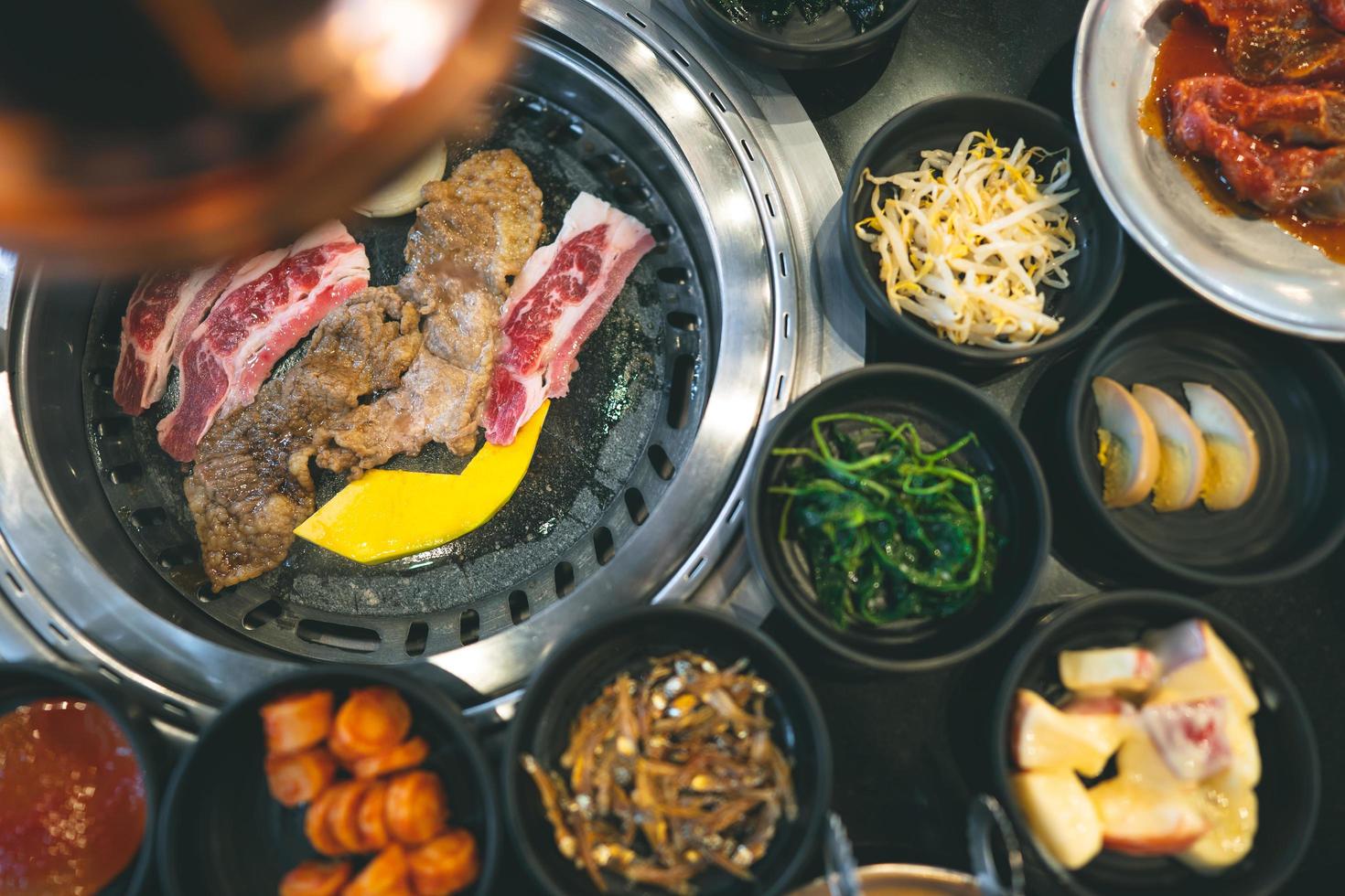 Top view of korea BBQ style restaurant with side dish photo