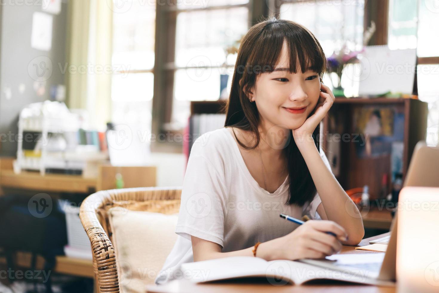 Asian teenager woman stay at home use internet for work and study photo