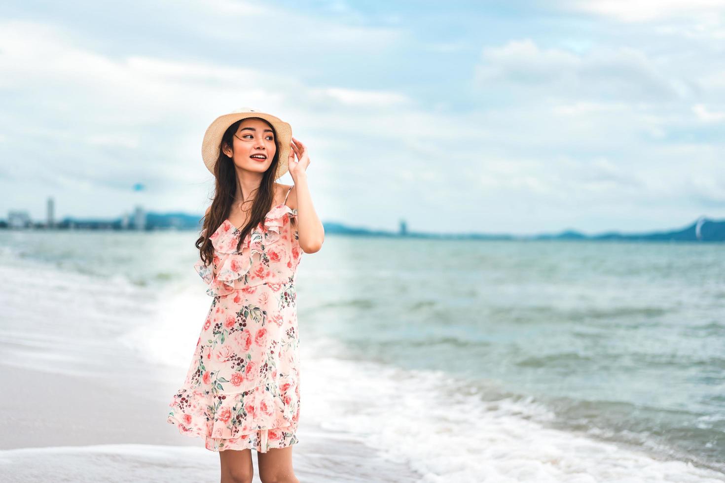 Asian young woman walk and relax on the beach photo