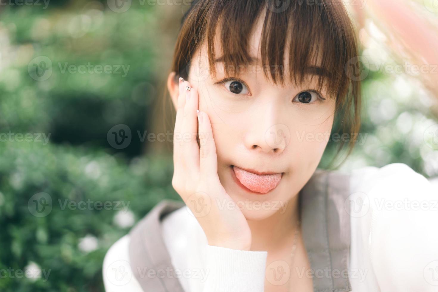 Portrait of young cute asian teenager student woman take a selfie photo by mobile phone