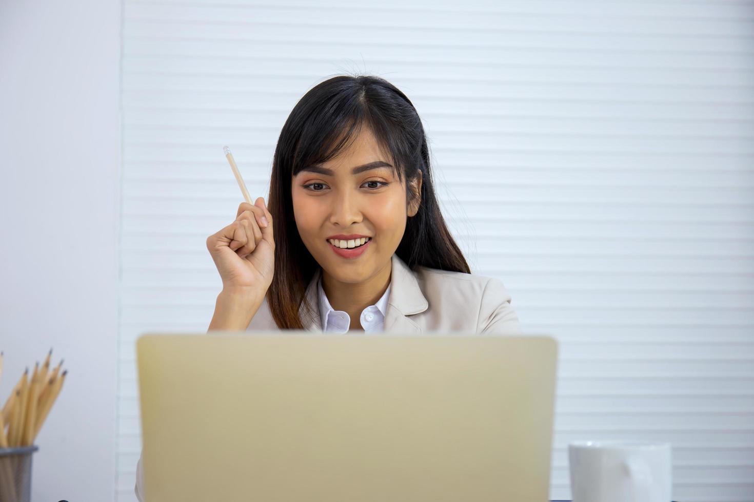 A young Asian professional businesswoman is sleeping on her desk. photo