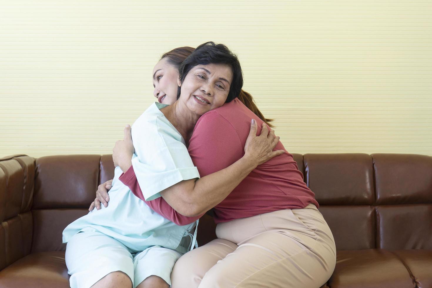 The ill Asian mother in the hospital was hugging her daughter with joy. photo