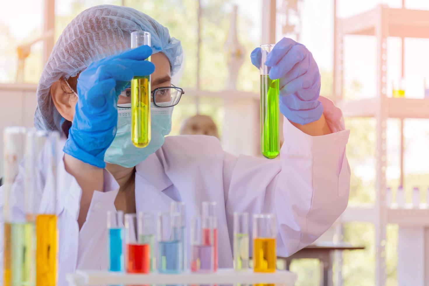 An Asian female scientist is researching a chemical formula in a lab. photo