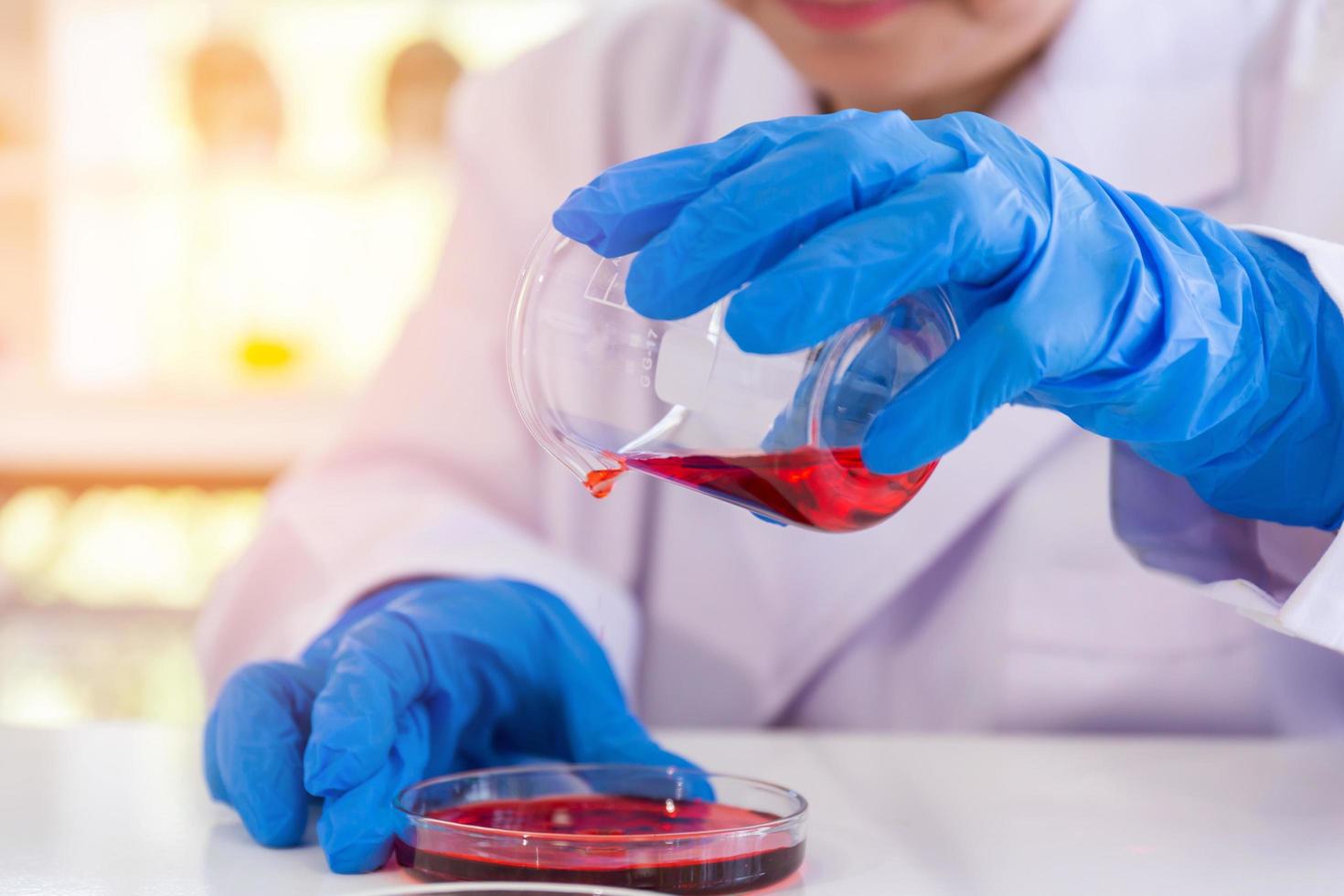 An Asian female scientist is researching a chemical formula in a lab. photo