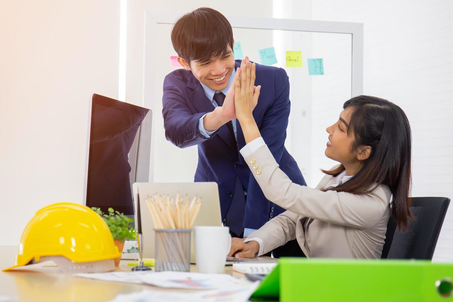 Asian male and female company employees work well together. photo