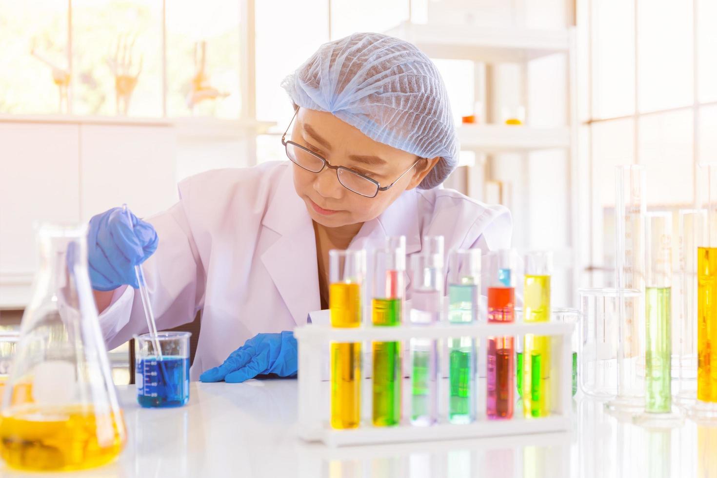 An Asian female scientist is researching a chemical formula in a lab. photo