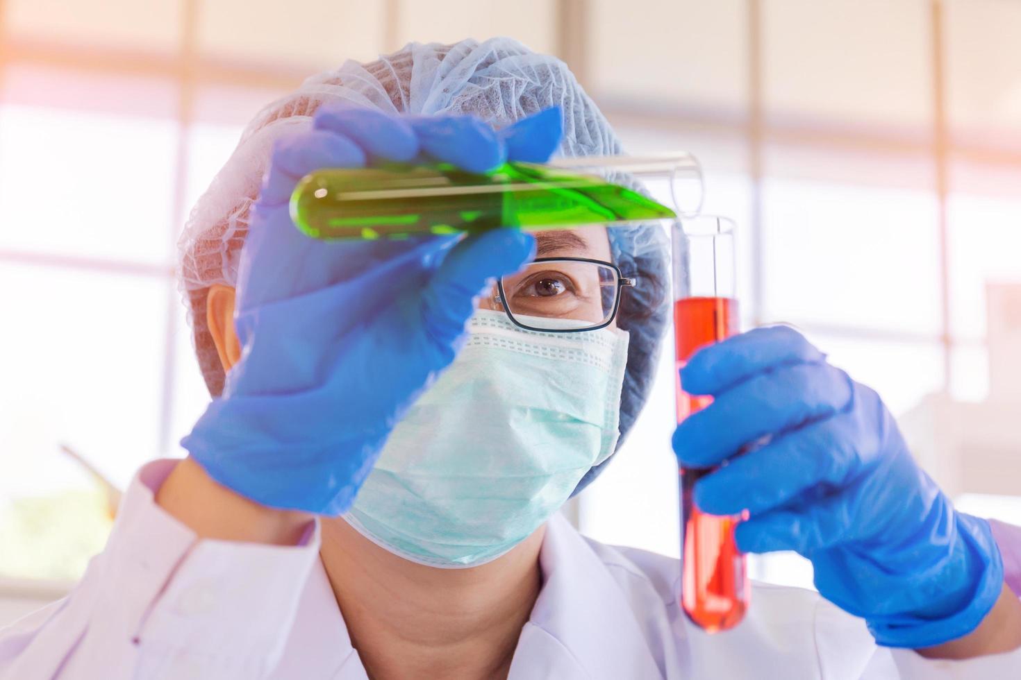 An Asian female scientist is researching a chemical formula in a lab. photo