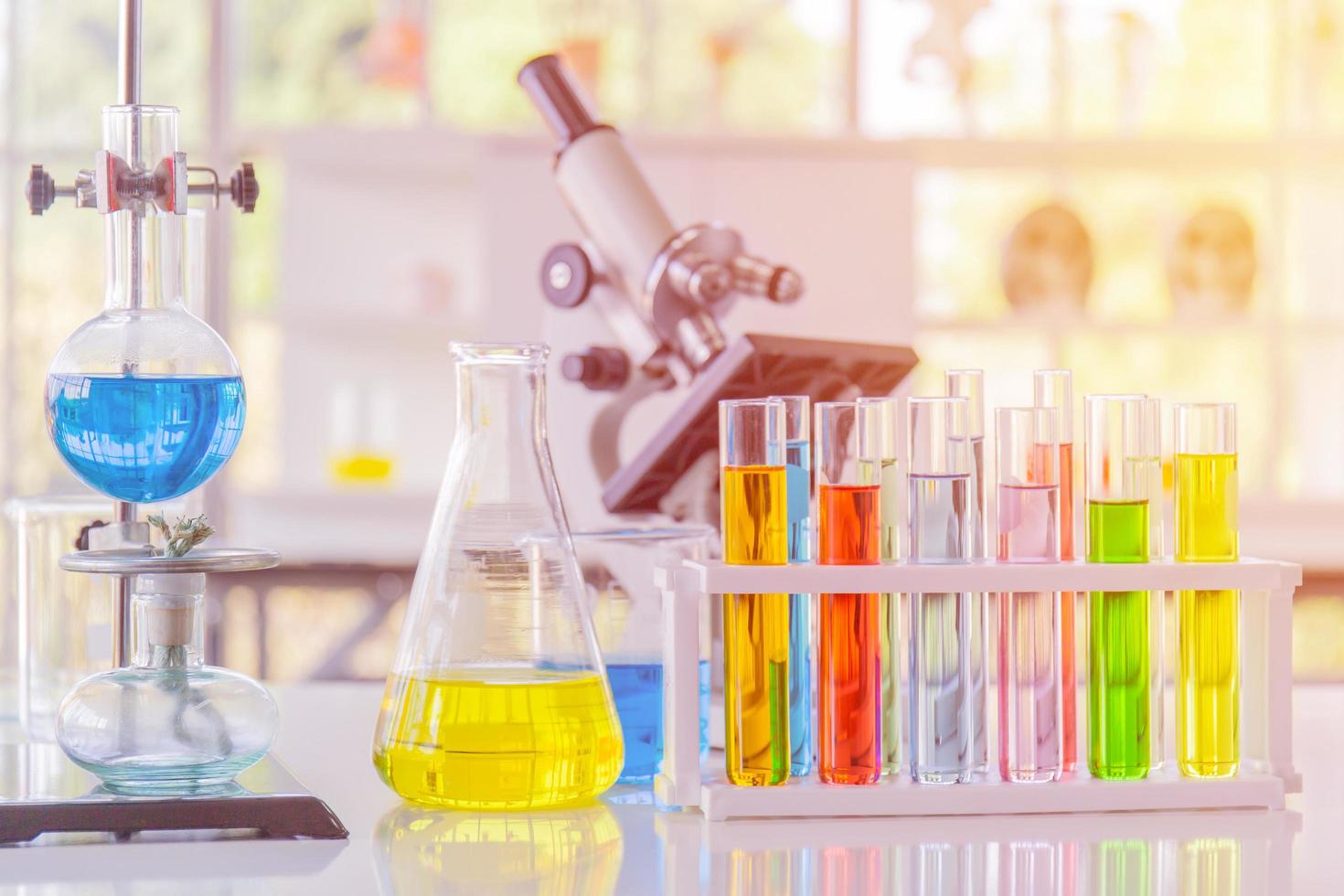 Chemical reagents in glass bottles of various shapes, scientific experiments of various sizes and with a beautiful orange light. photo