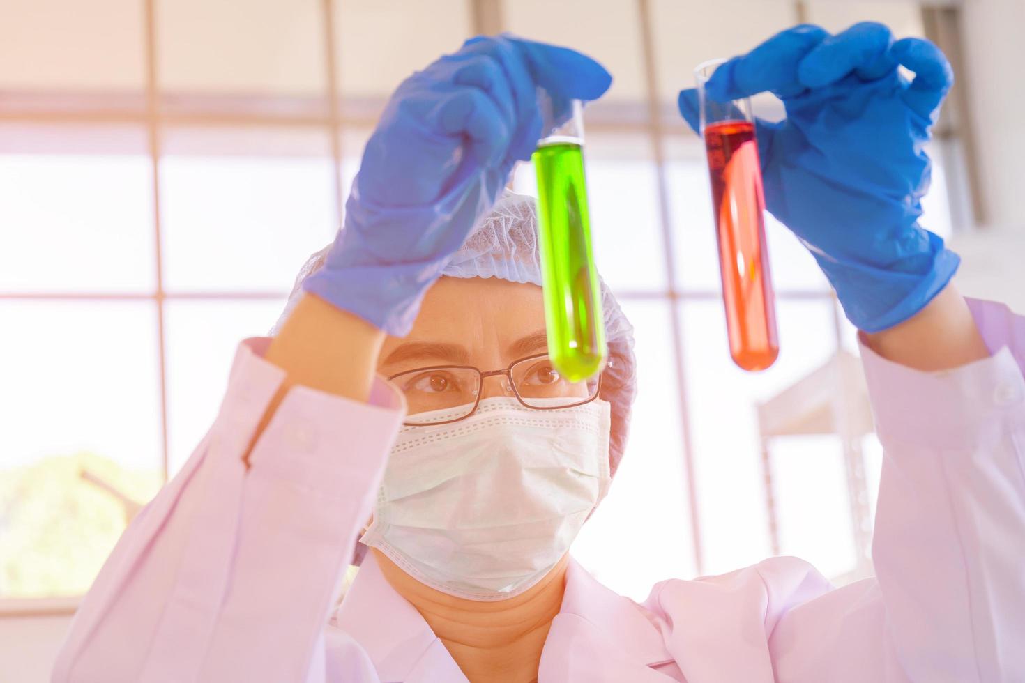 An Asian female scientist is researching a chemical formula in a lab. photo