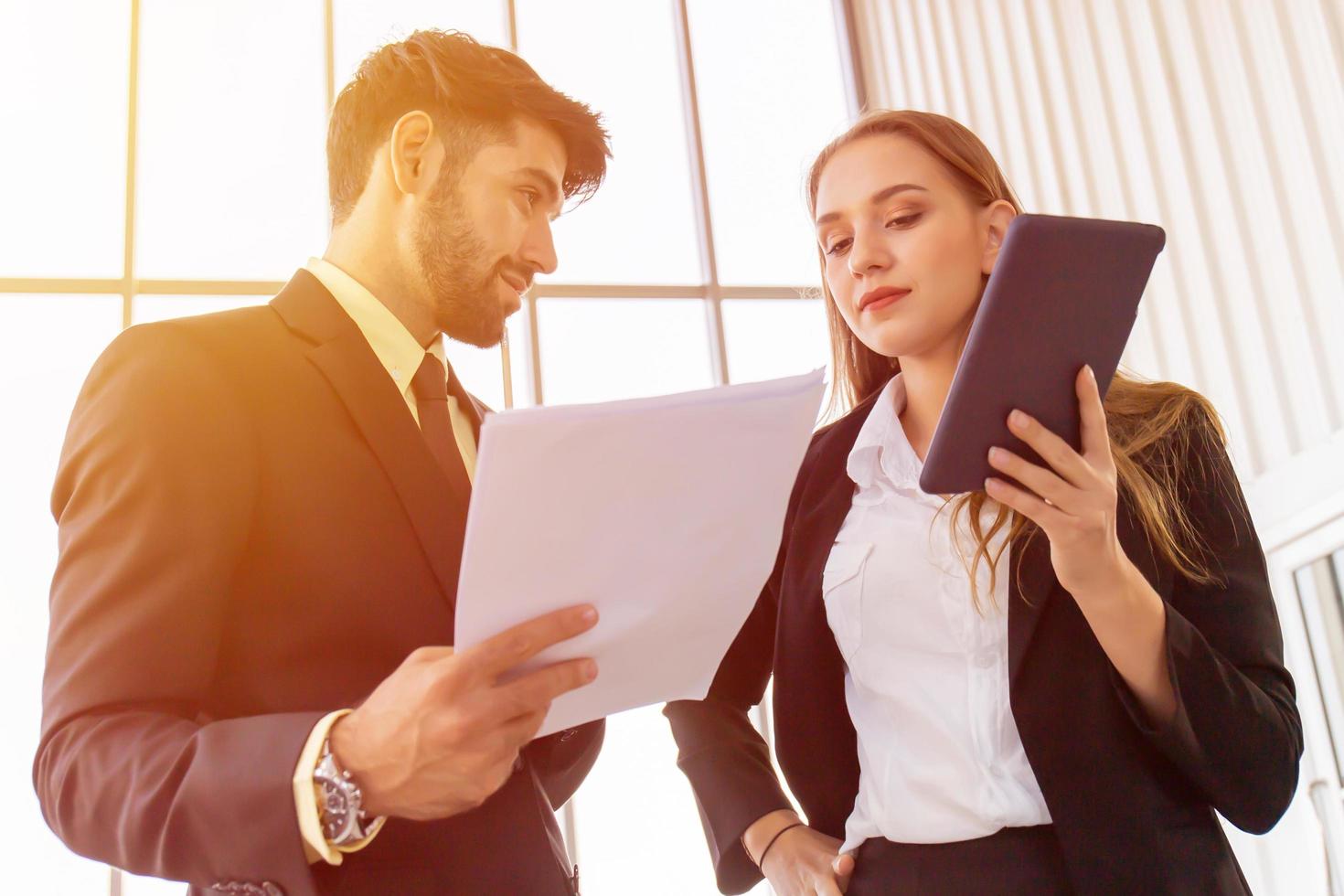 Two business men and women standing meeting in the office photo