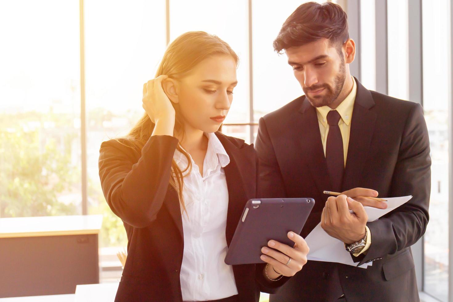 Two business men and women standing meeting in the office photo