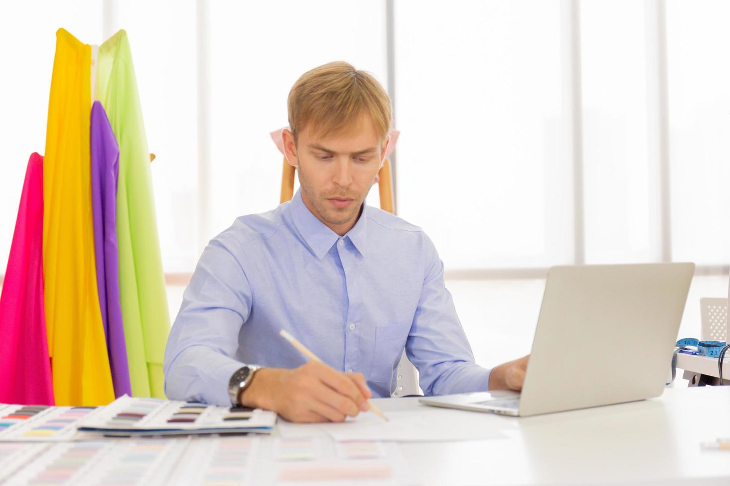 Professional male sewing designers in the office, with a variety of colored vegetables. photo