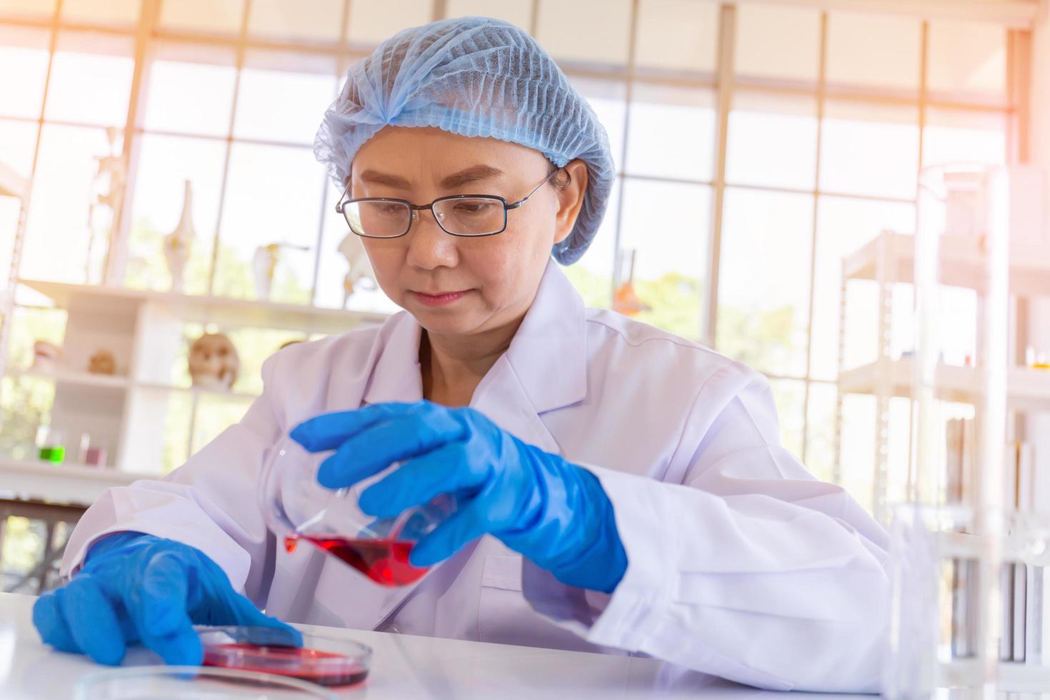 An Asian female scientist is researching a chemical formula in a lab. photo