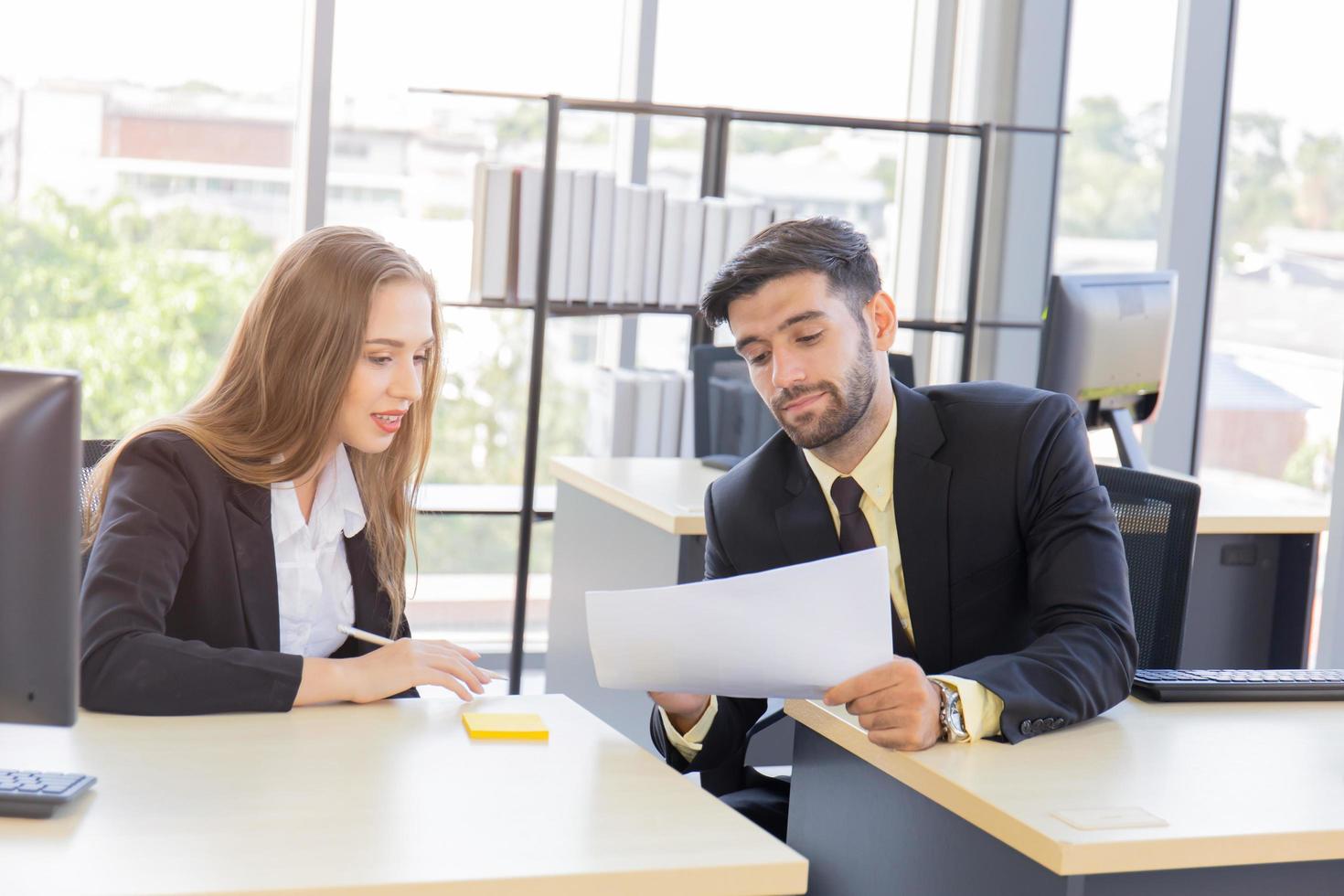 Two young business men, men and women Dew, work at the office with happiness photo